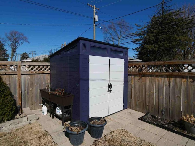 view of shed with a fenced backyard