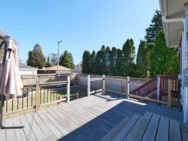 wooden deck featuring a fenced backyard