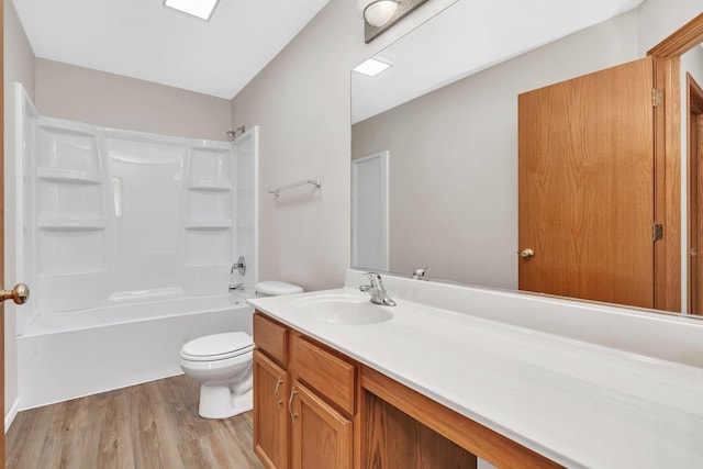 bathroom with toilet, vanity, bathtub / shower combination, and wood finished floors