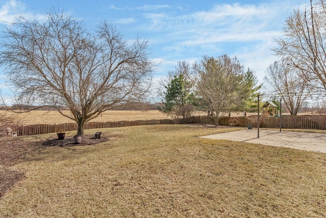 view of yard with a patio, a playground, and a fenced backyard