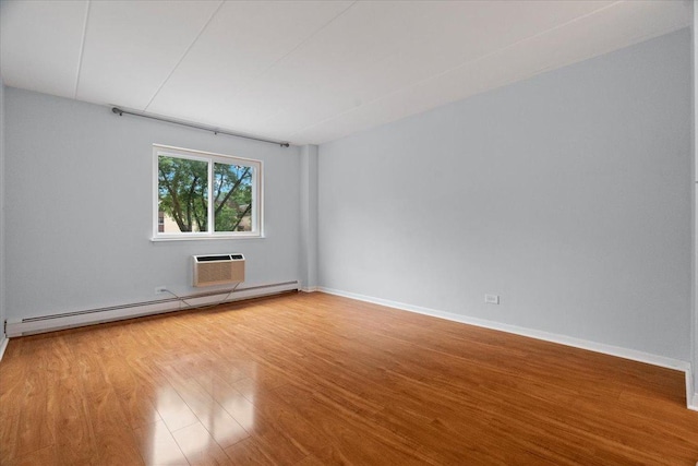 unfurnished room with baseboards, baseboard heating, a wall mounted air conditioner, and wood finished floors