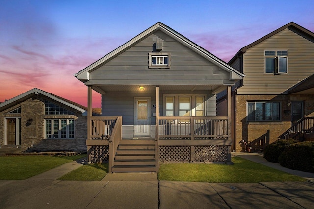 view of front of house featuring brick siding and covered porch