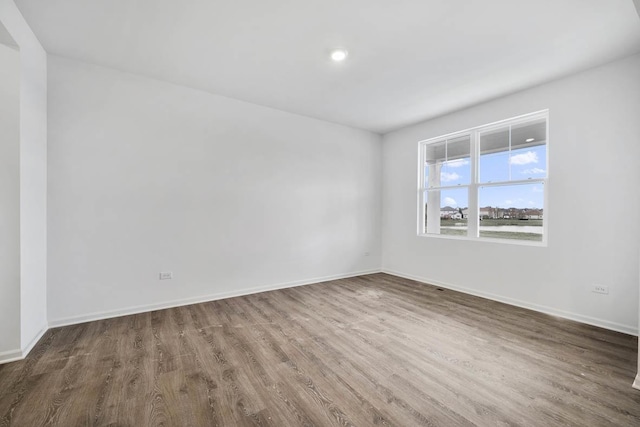 unfurnished room featuring wood finished floors and baseboards