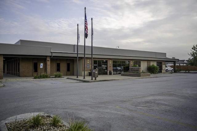 view of building exterior with uncovered parking