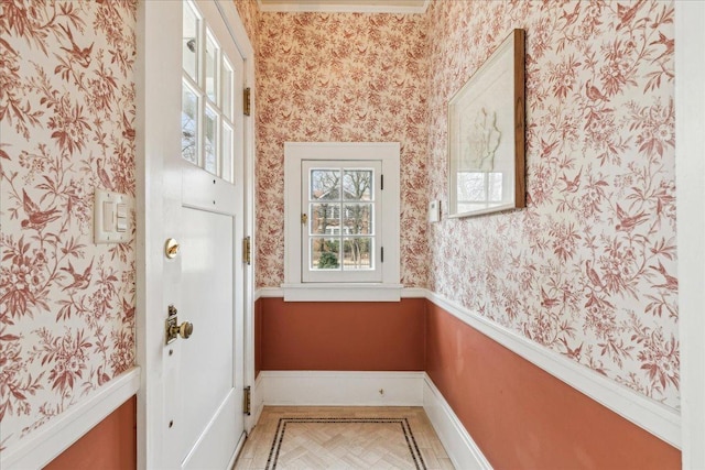 interior space with wallpapered walls and baseboards