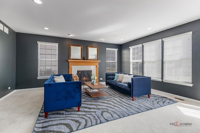 carpeted living area featuring visible vents, recessed lighting, a fireplace, and baseboards