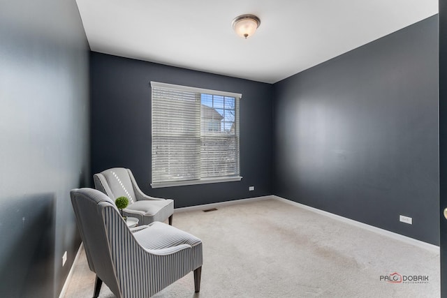 living area featuring carpet flooring, visible vents, and baseboards