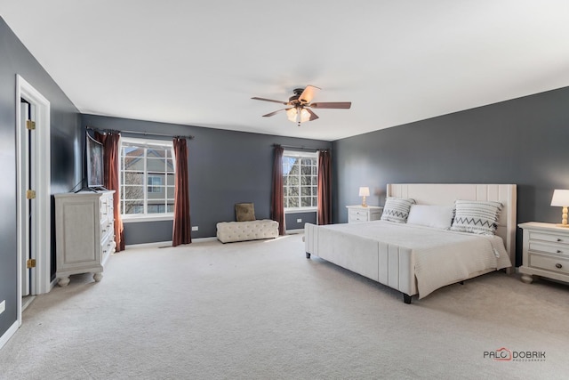 carpeted bedroom featuring baseboards and ceiling fan