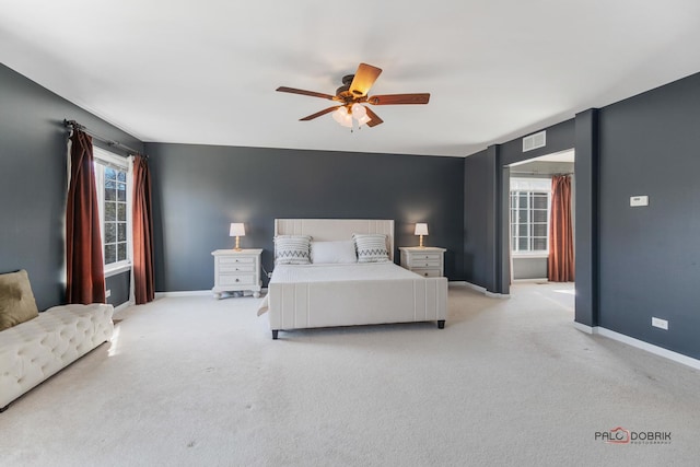 bedroom with light carpet, visible vents, and baseboards