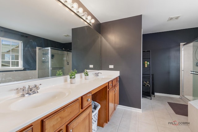 bathroom with a sink, visible vents, a stall shower, and tile patterned floors