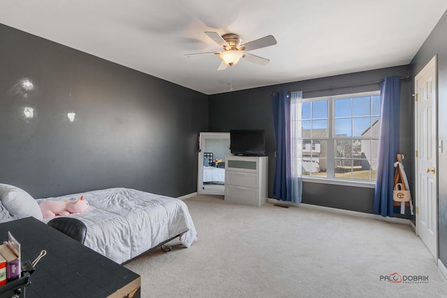 carpeted bedroom featuring ceiling fan and baseboards