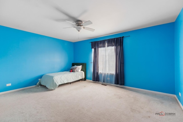 unfurnished bedroom with a ceiling fan, carpet, visible vents, and baseboards