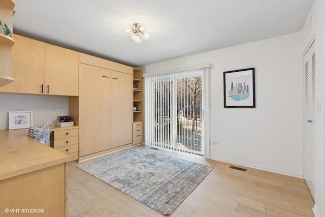 kitchen featuring visible vents, light brown cabinetry, light countertops, light wood-type flooring, and open shelves