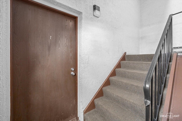 staircase with a textured wall