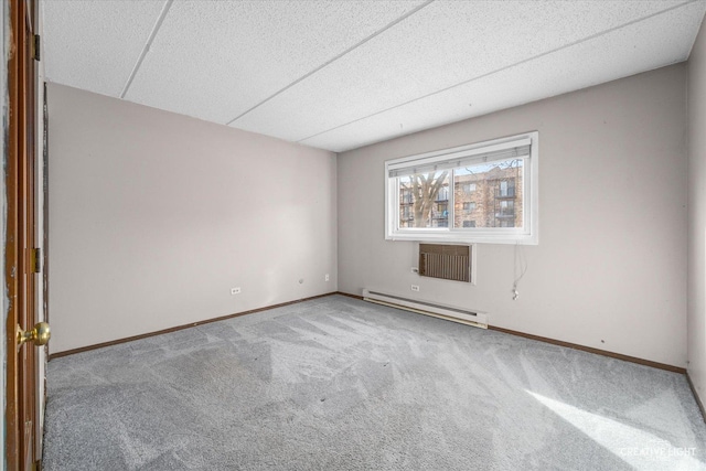 carpeted spare room featuring a baseboard radiator and baseboards