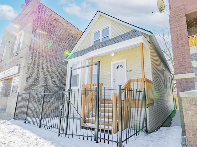 view of front of house featuring a gate, covered porch, and a fenced front yard