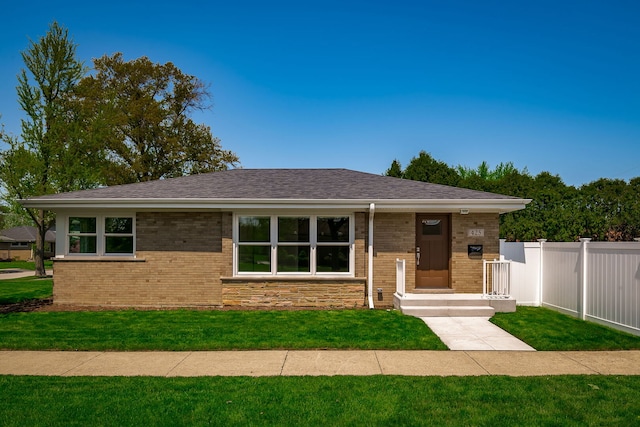 view of front of property with brick siding and roof with shingles
