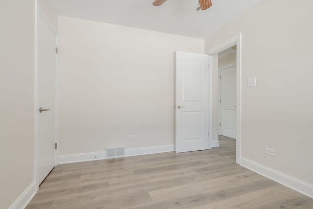 unfurnished bedroom with light wood-style floors, baseboards, and a ceiling fan