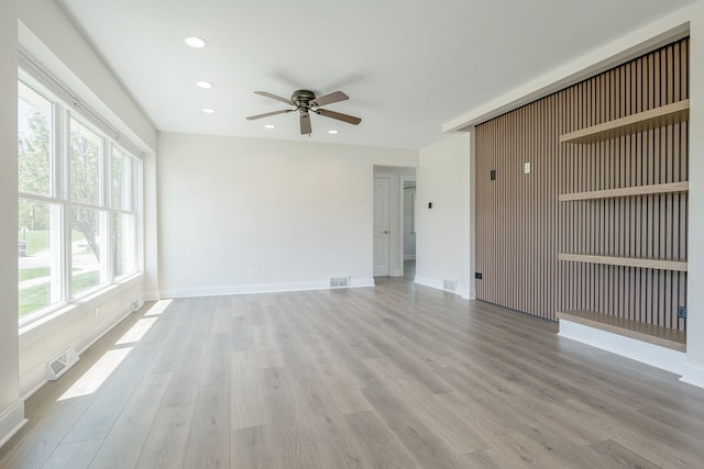 unfurnished living room with a ceiling fan, light wood-type flooring, recessed lighting, and baseboards