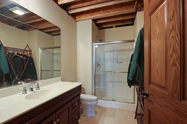 bathroom with vanity, toilet, a shower stall, and tile patterned flooring