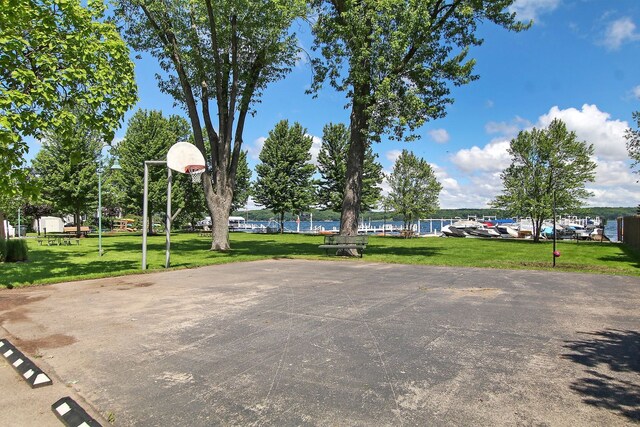 view of sport court with community basketball court and a lawn