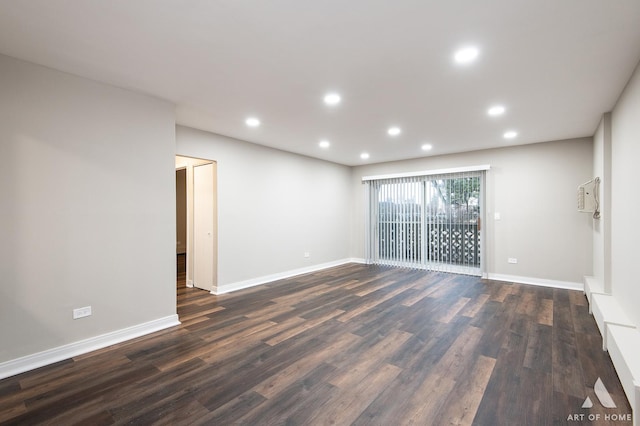 unfurnished room with recessed lighting, dark wood-type flooring, and baseboards