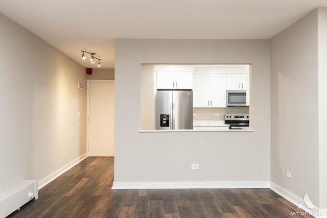 kitchen featuring white cabinetry, baseboards, dark wood-style flooring, and appliances with stainless steel finishes