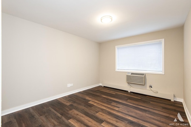 empty room featuring dark wood-style floors, a wall mounted AC, and baseboards