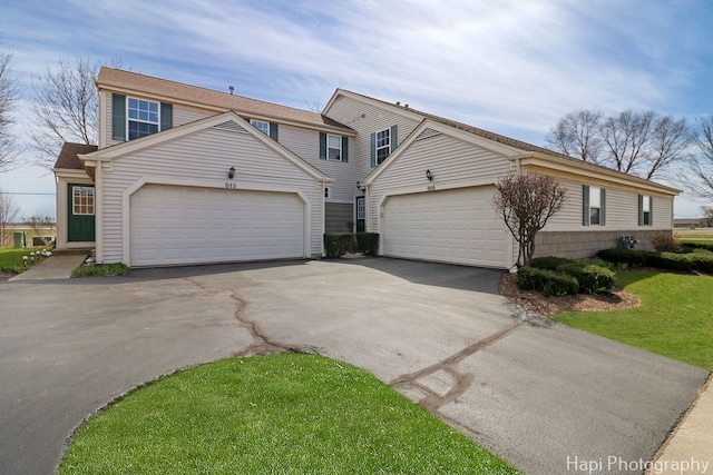 view of front of property with driveway, a front yard, and a garage