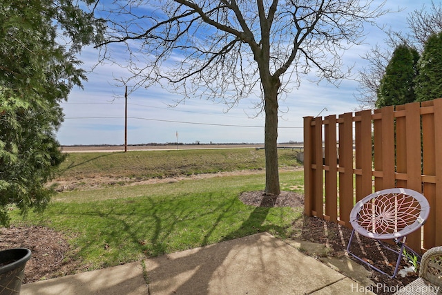 view of yard featuring fence and a rural view