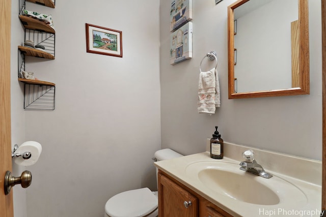 bathroom with toilet and vanity