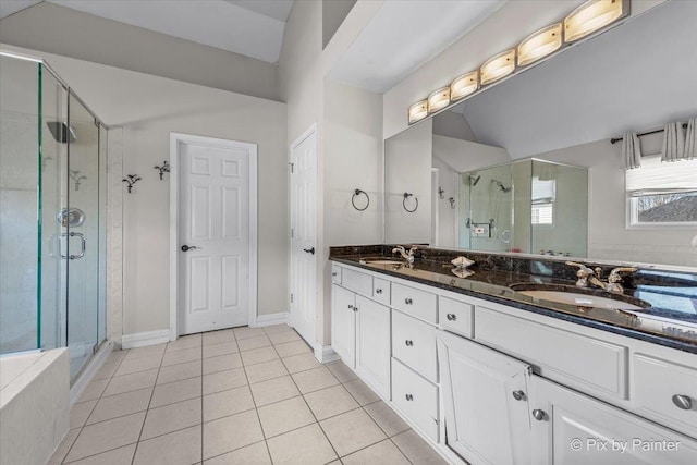 full bathroom featuring tile patterned flooring, a shower stall, double vanity, and a sink