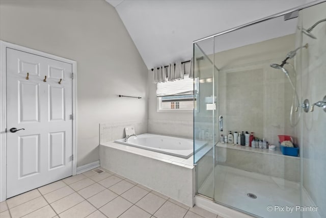 full bath with a shower stall, a bath, vaulted ceiling, and tile patterned flooring