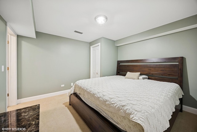 carpeted bedroom with a closet, visible vents, and baseboards