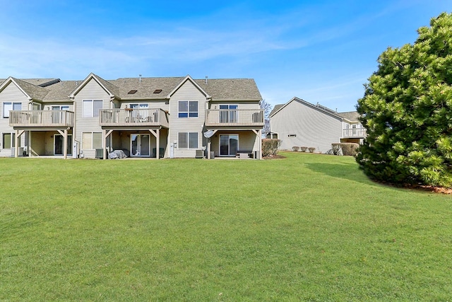 rear view of property featuring a yard