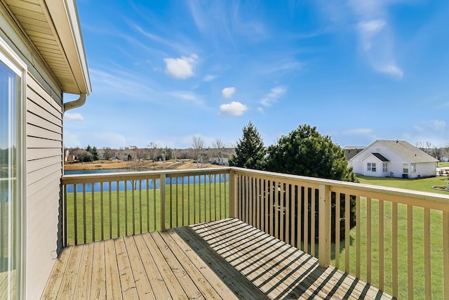 deck with a yard and a water view