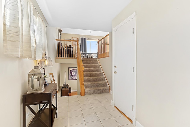 stairway with tile patterned floors and baseboards