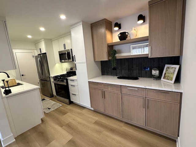 kitchen featuring decorative backsplash, recessed lighting, light wood-style floors, stainless steel appliances, and open shelves