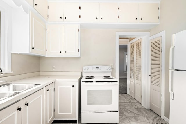 kitchen with light countertops, marble finish floor, white appliances, white cabinetry, and a sink