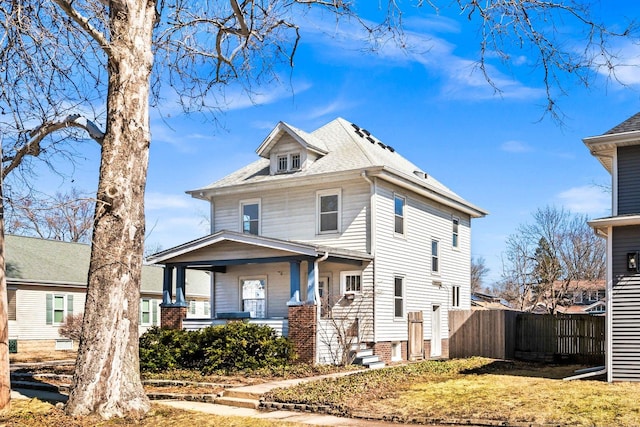 view of front of house featuring a porch and fence