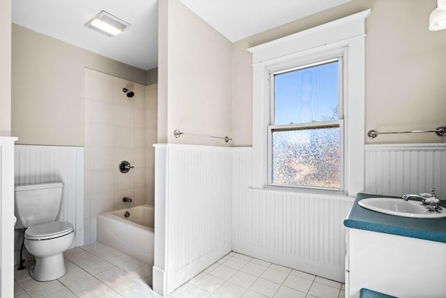 bathroom with vanity, tile patterned floors, toilet, and wainscoting