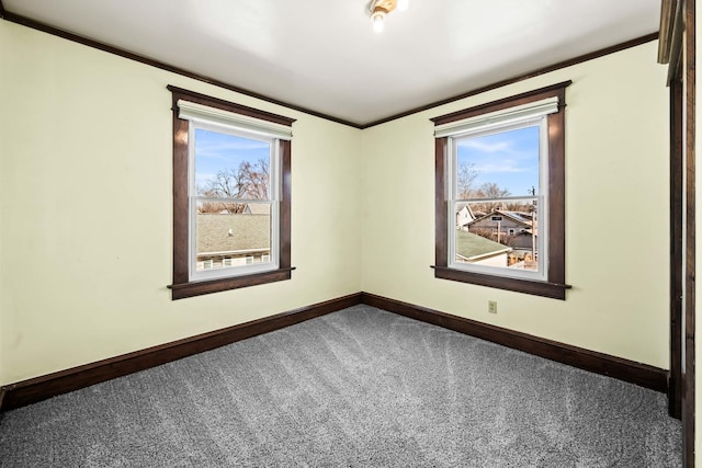 carpeted empty room featuring baseboards, a healthy amount of sunlight, and crown molding