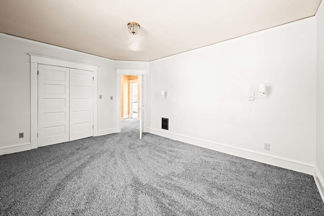 unfurnished bedroom featuring a closet, baseboards, and carpet