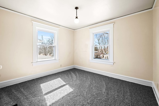 empty room featuring baseboards and carpet floors