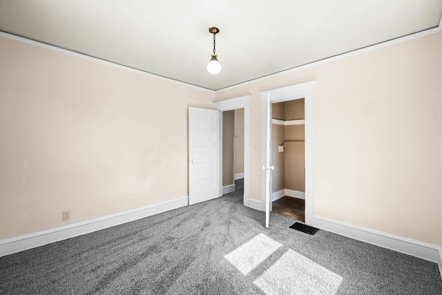 unfurnished bedroom featuring visible vents, baseboards, and carpet floors