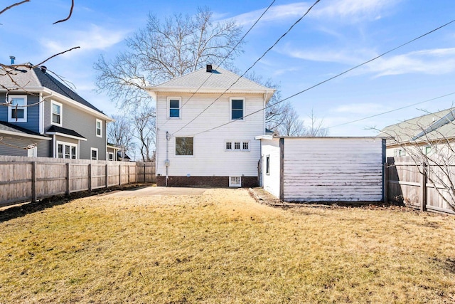 back of property with a fenced backyard, a lawn, and central AC