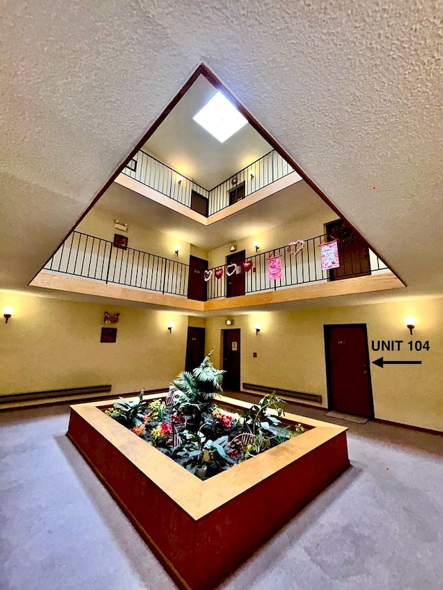 interior space featuring carpet floors and a textured ceiling