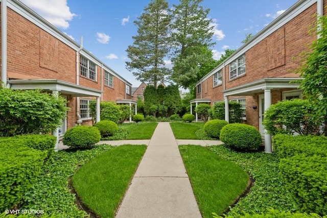 view of home's community with a lawn