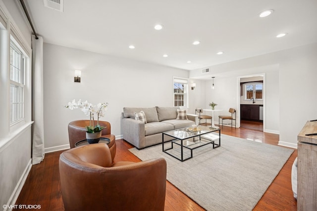 living area featuring visible vents, recessed lighting, and wood finished floors