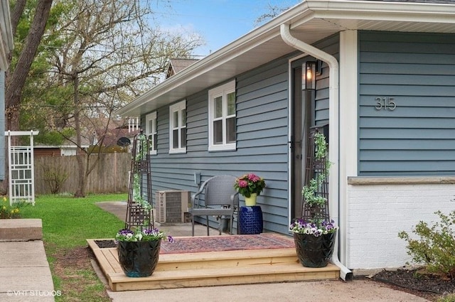 exterior space with fence and a lawn